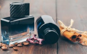 black bottle of perfume placed on a wooden table 2023 11 27 05 28 02 utc3